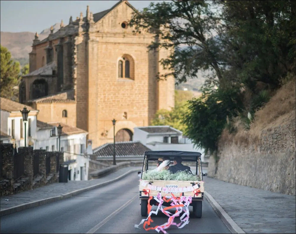 Wedding car in front of a historic church in Andalusia